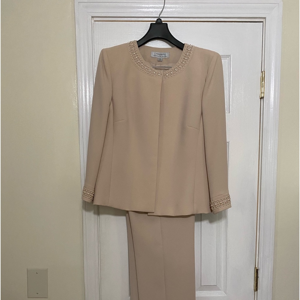 Peach ladies pants suit trimmed in pearls.
